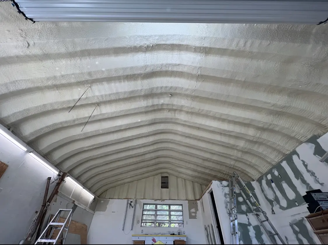 Spray polyurethane foam applied to the underside of a metal roof deck in Urbana